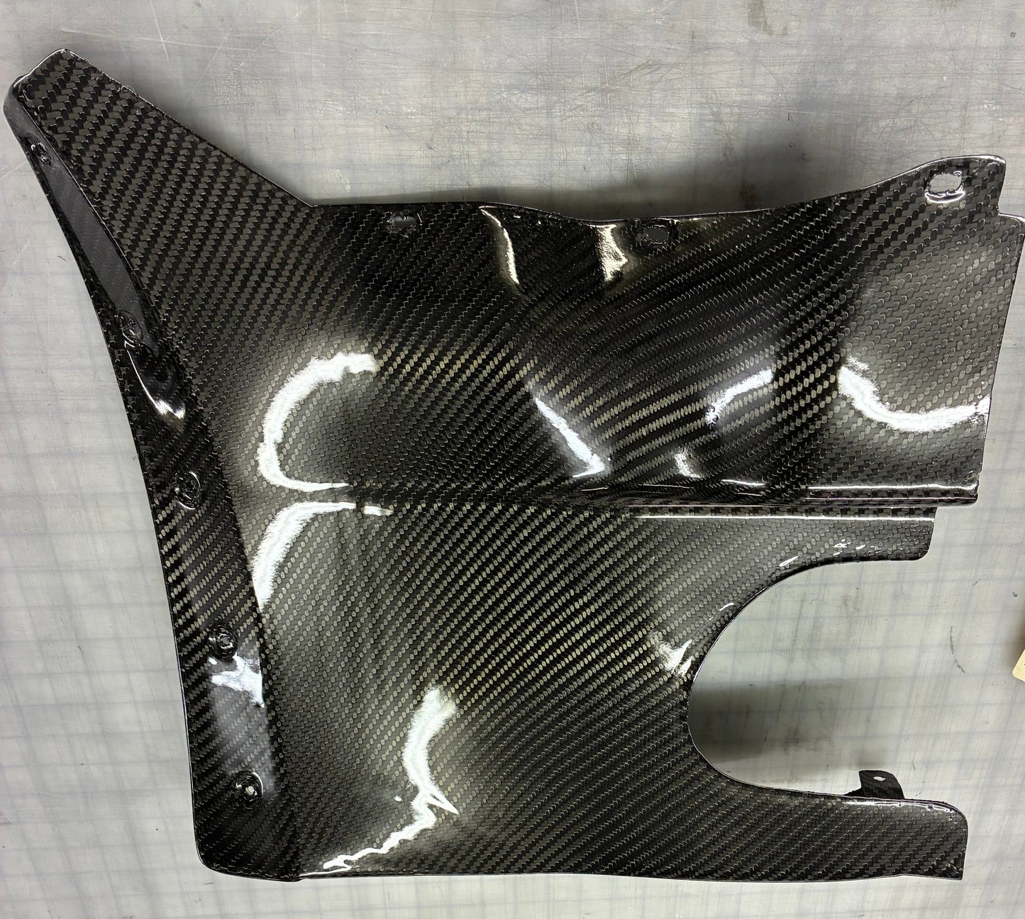 Carbon fiber panel on a gray surface