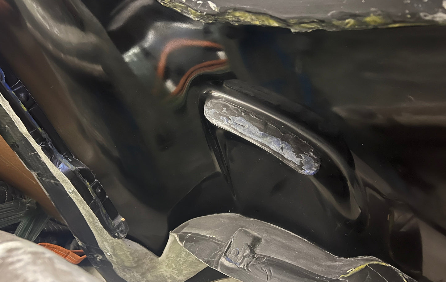 Close-up view of a polished carbon fiber mold surface
