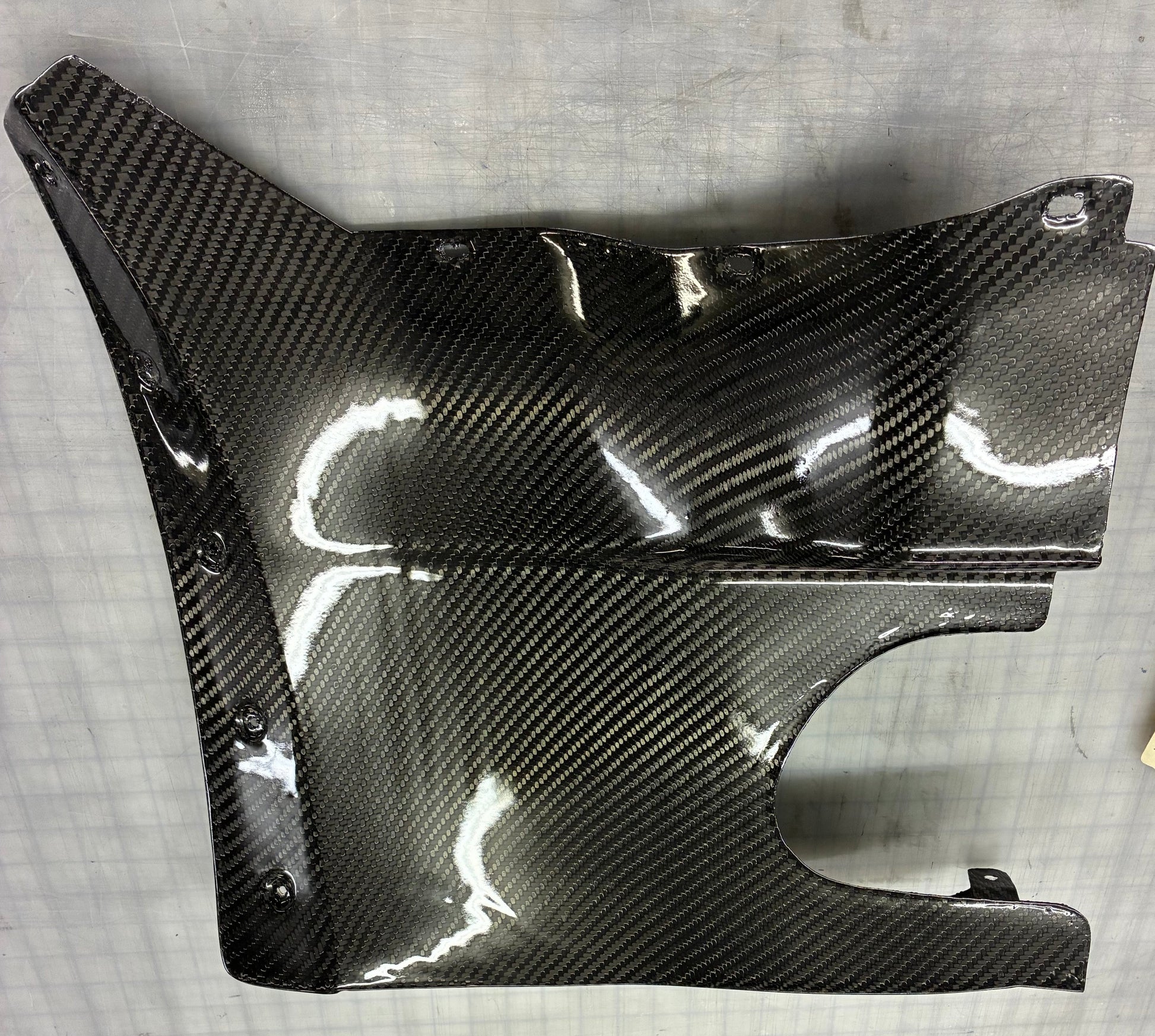 Carbon fiber panel on a gray surface
