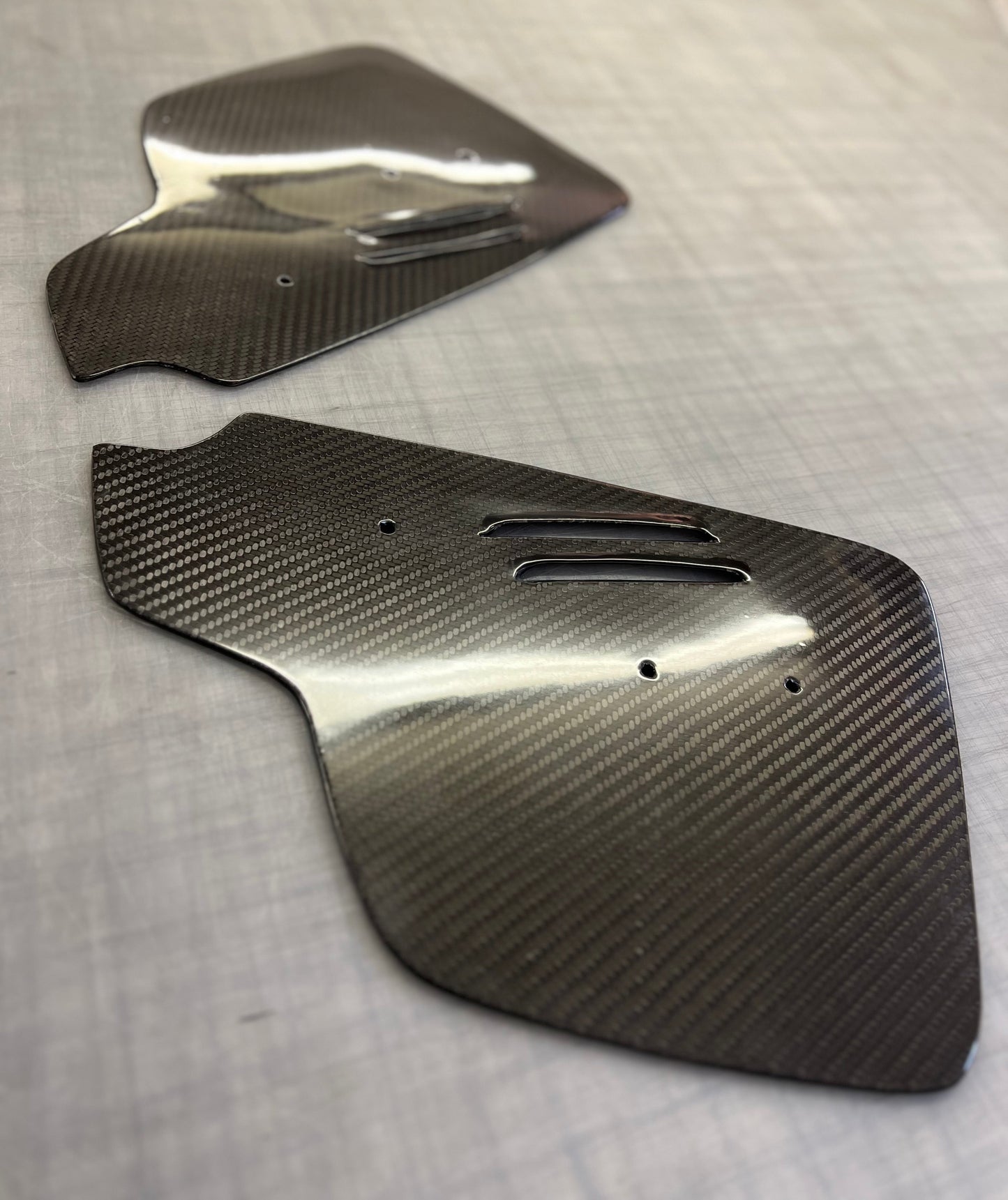 Carbon fiber panels on a gray surface