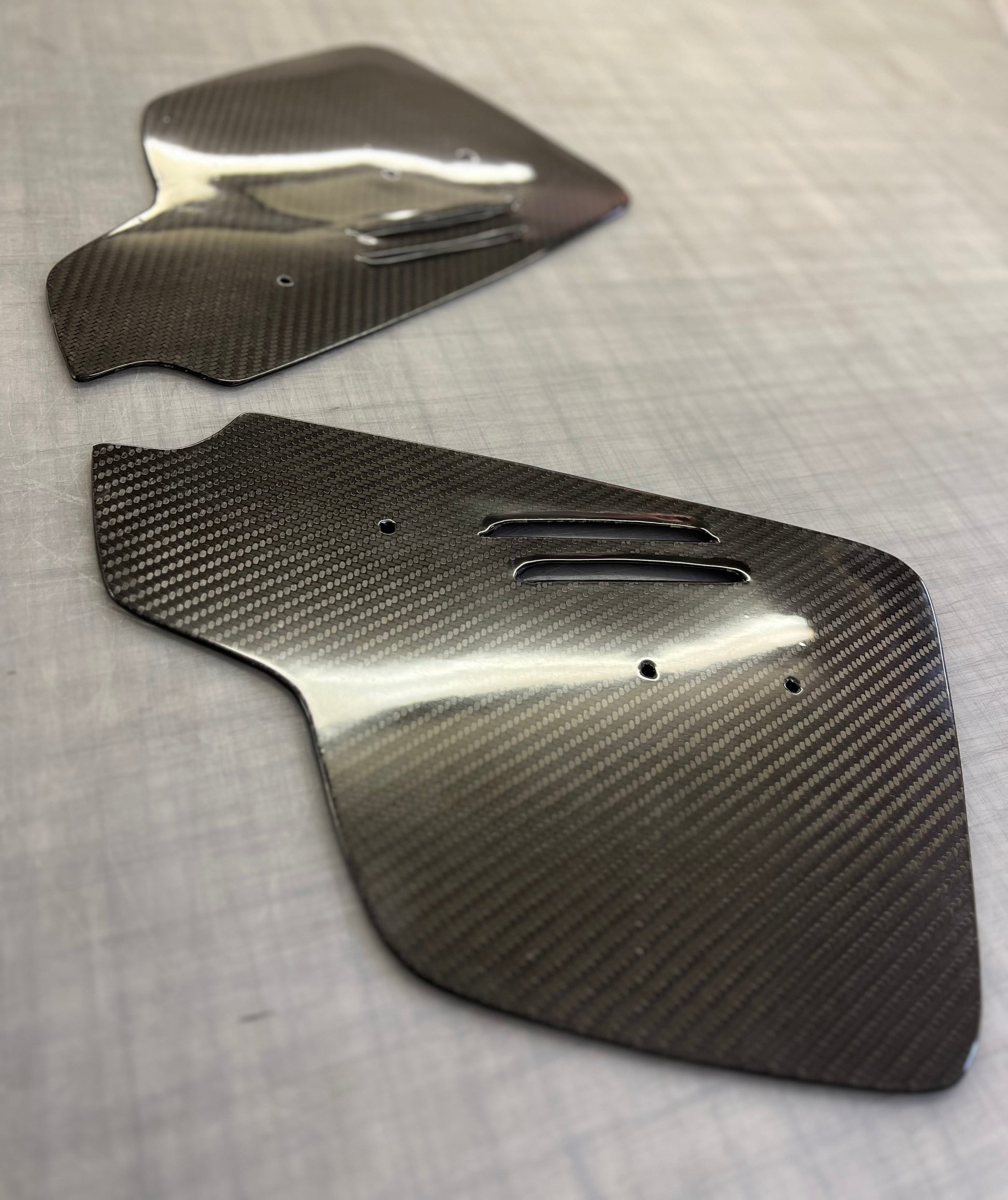 Carbon fiber panels on a gray surface