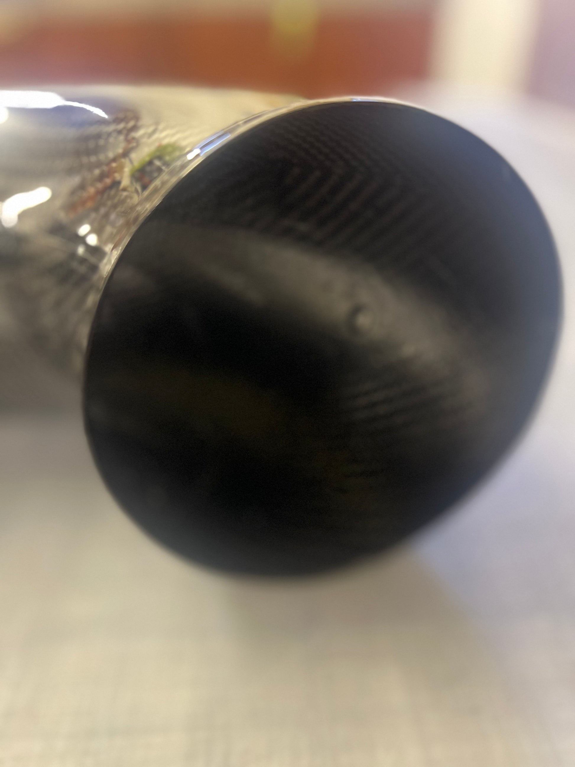 Close-up of a black object on a reflective surface