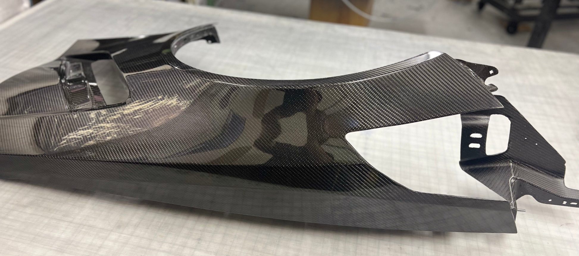 Carbon fiber C7 corvette fender on a white table