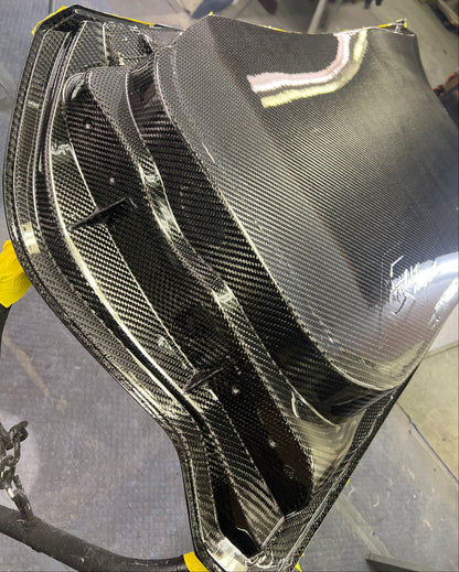 Carbon fiber car part on a gray surface