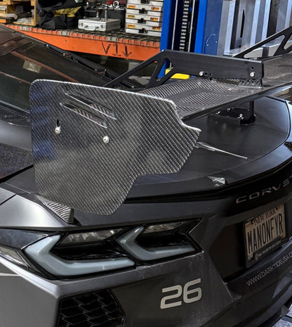 Car with a carbon fiber splitter in a warehouse setting