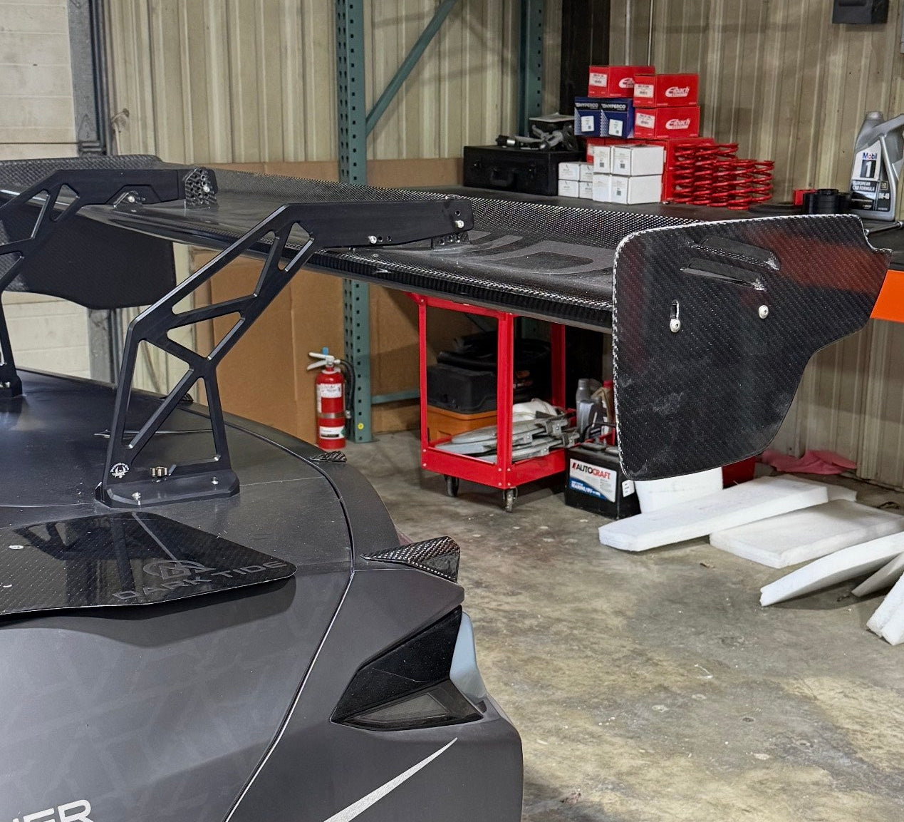 Car in a garage with tools and equipment around