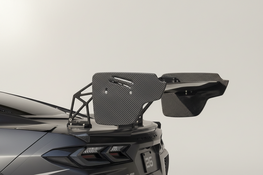 Carbon fiber car spoiler on a vehicle with a plain background