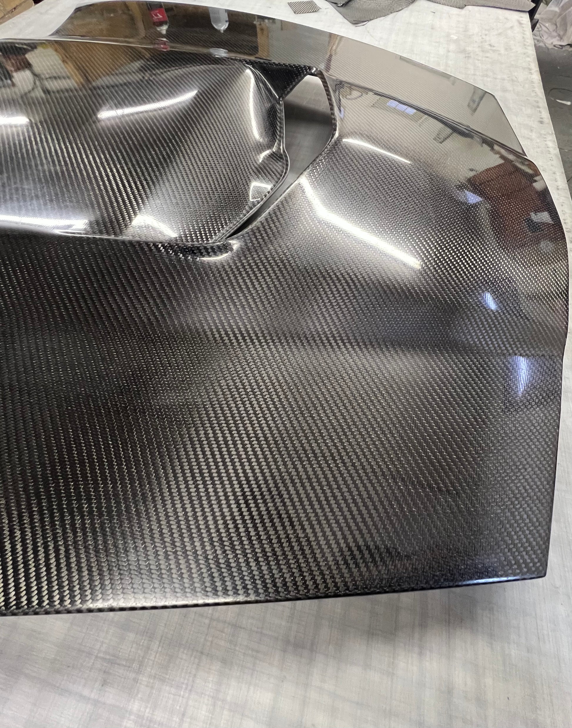 Carbon fiber panel with a smooth surface on a light gray background