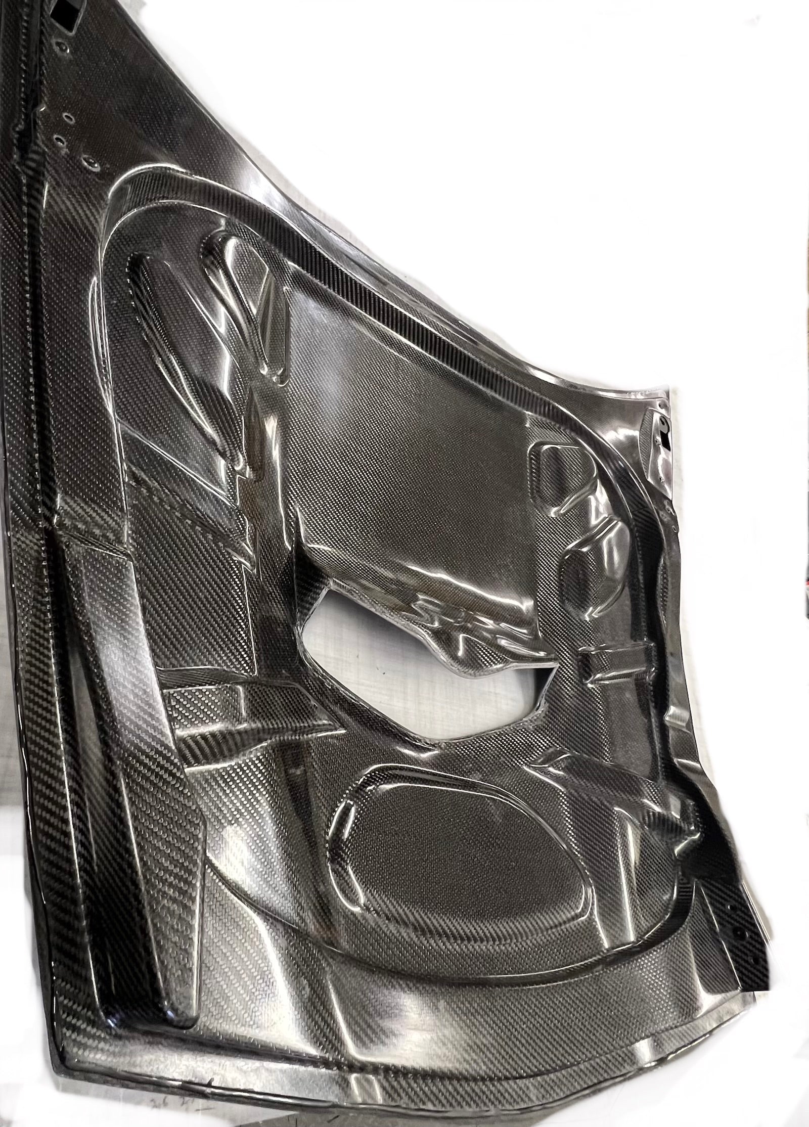 car hood with a carbon fiber finish on a white background