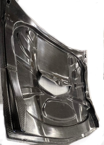 car hood with a carbon fiber finish on a white background