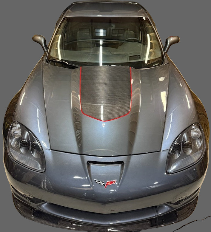 Gray sports car with red accents in a garage setting