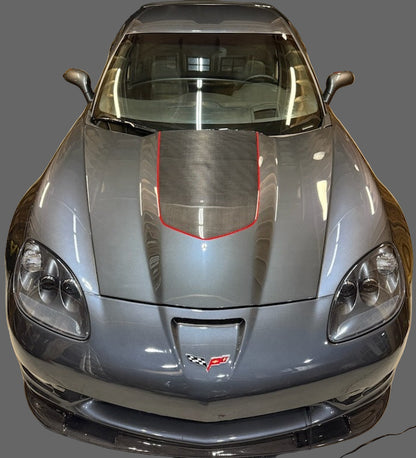 Gray sports car with red accents in a garage setting